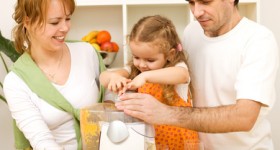 Family making fresh fruit juice together Family making fresh fruit juice together