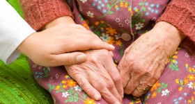 A doctor holding an old woman's hand - part of a series. A doctor holding an old woman's hand - part of a series.