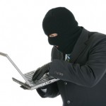Computer criminal - Hacker with laptop computer Computer criminal - Hacker with laptop computer