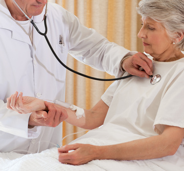 Senior doctor taking the heartbeat of his patient