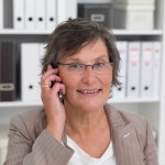 Business woman using cellphone in the office