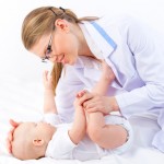 Beautiful baby at the doctor pediatrician isolated on white